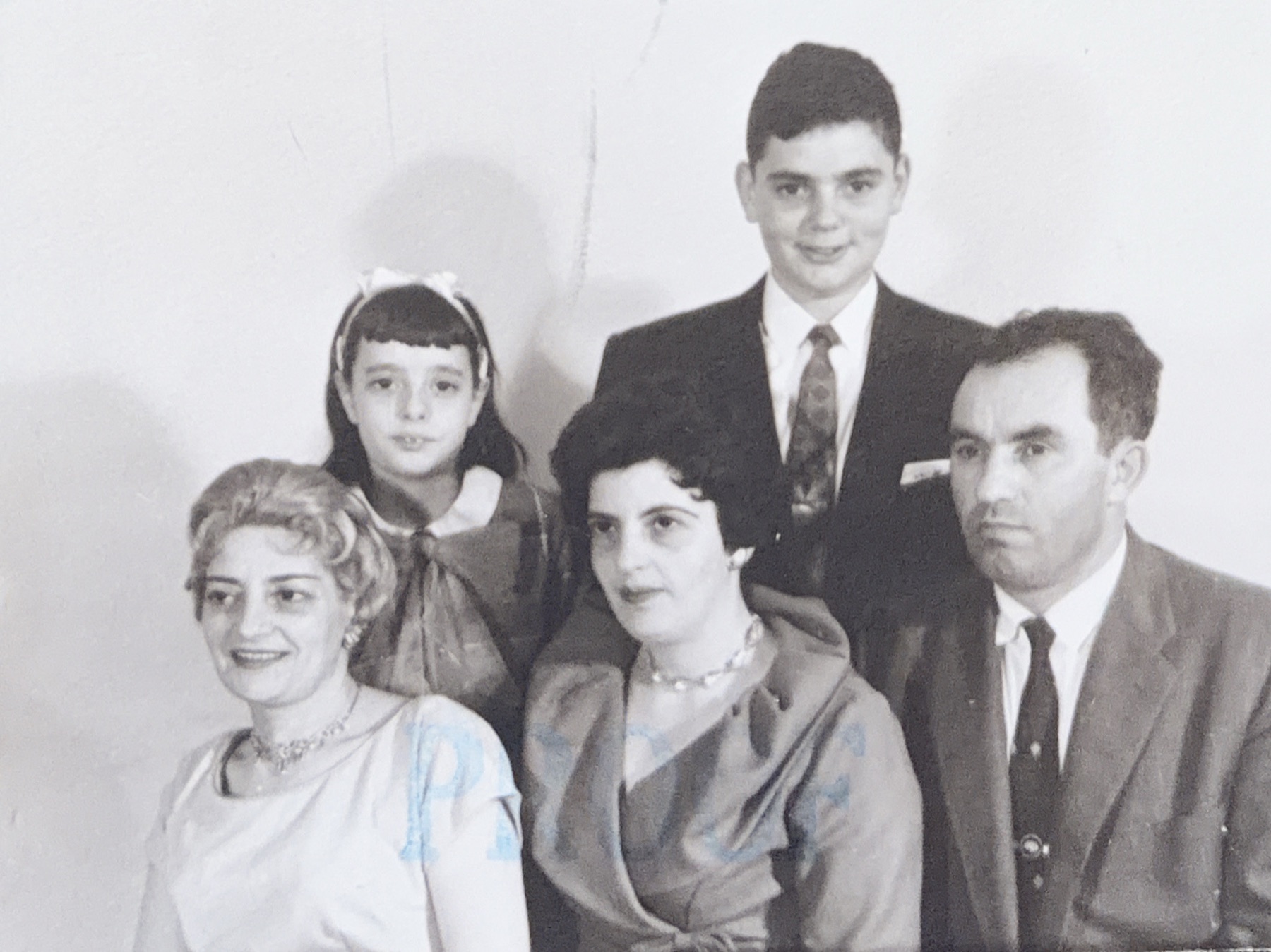 A formal black and white portrait of the Norman family