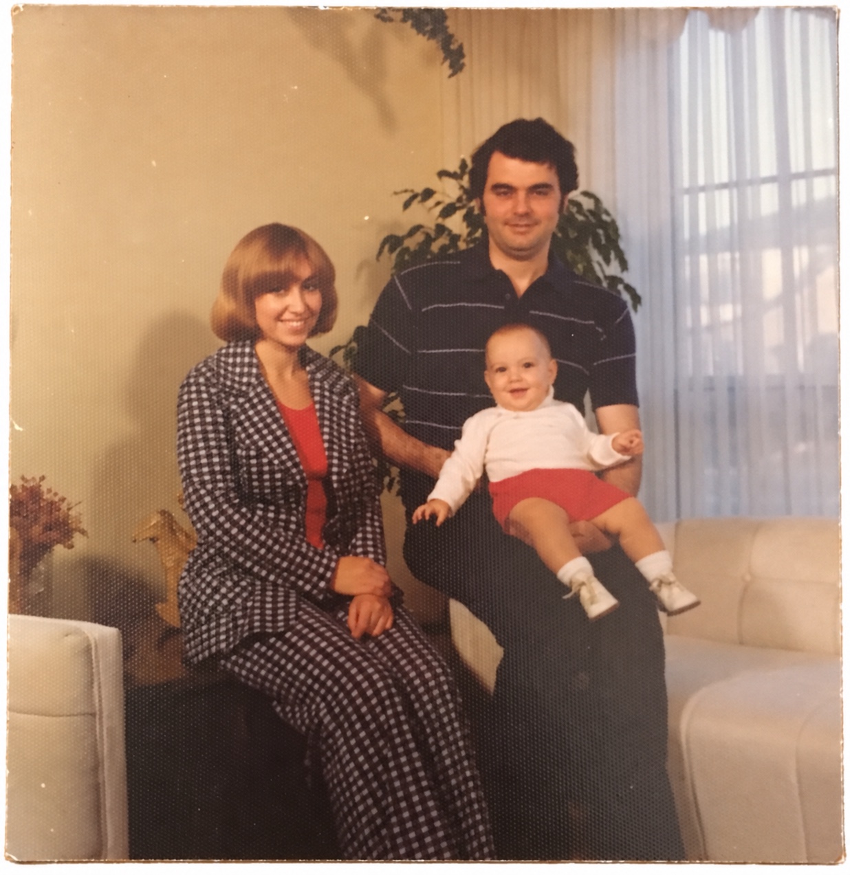 A young Morris and Julie posing with their baby