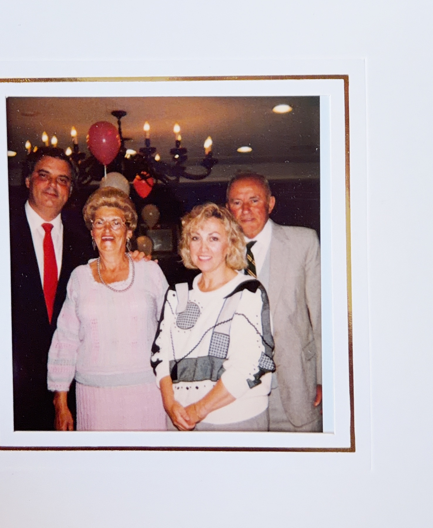 Morris standing with his parents and a relative at a party