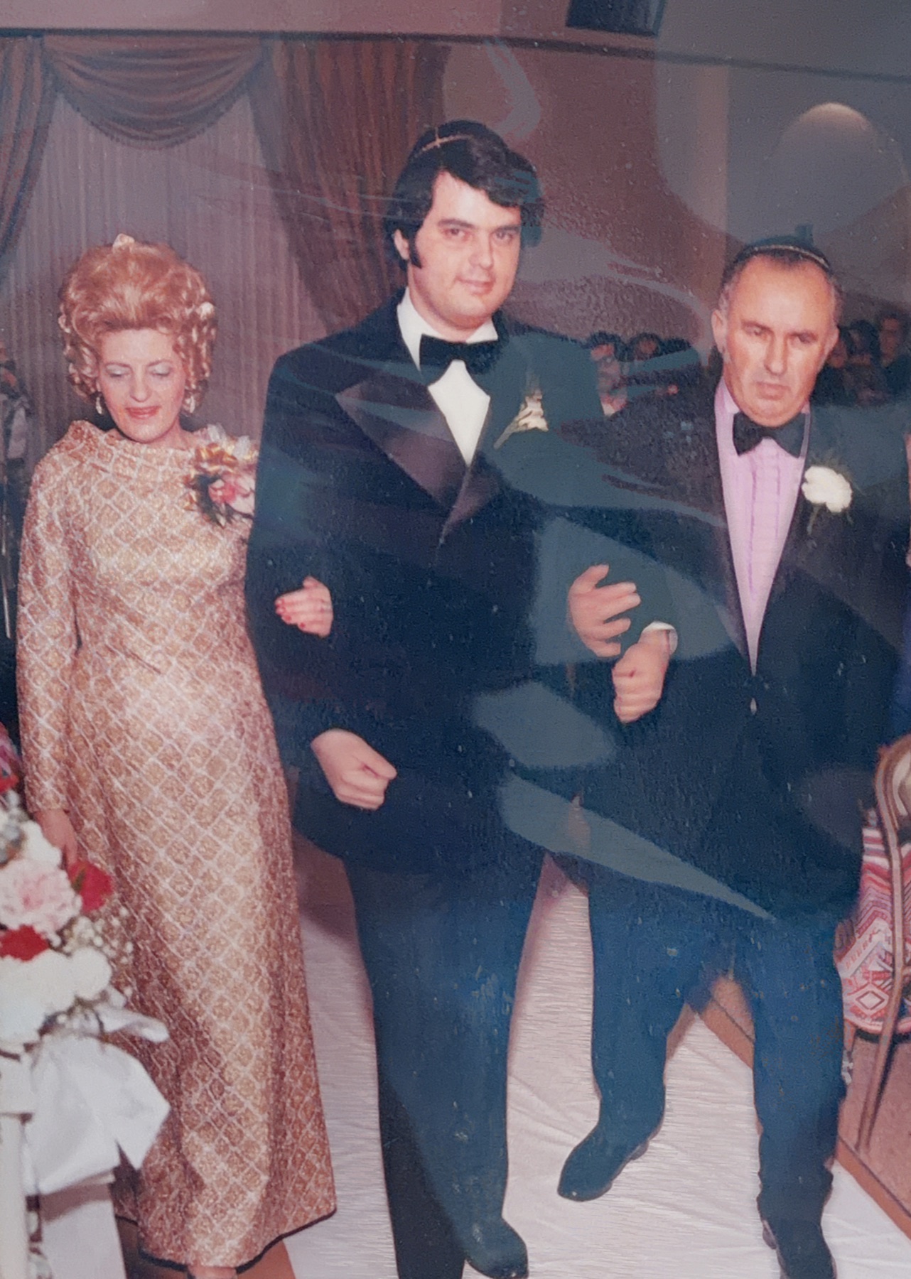 Morris walking arm in arm with his parents