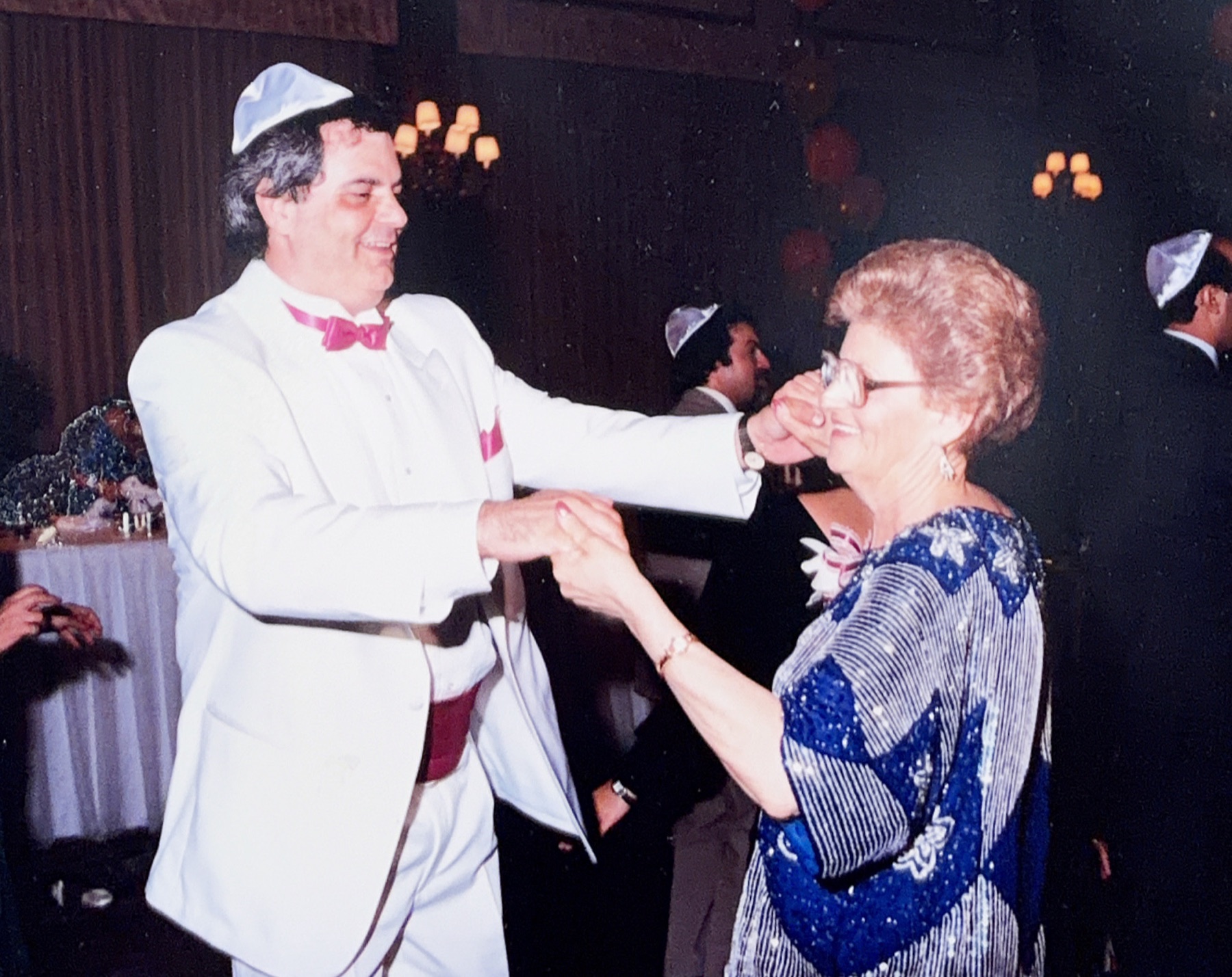 Morris in a white dinner jacket dancing with an older relative