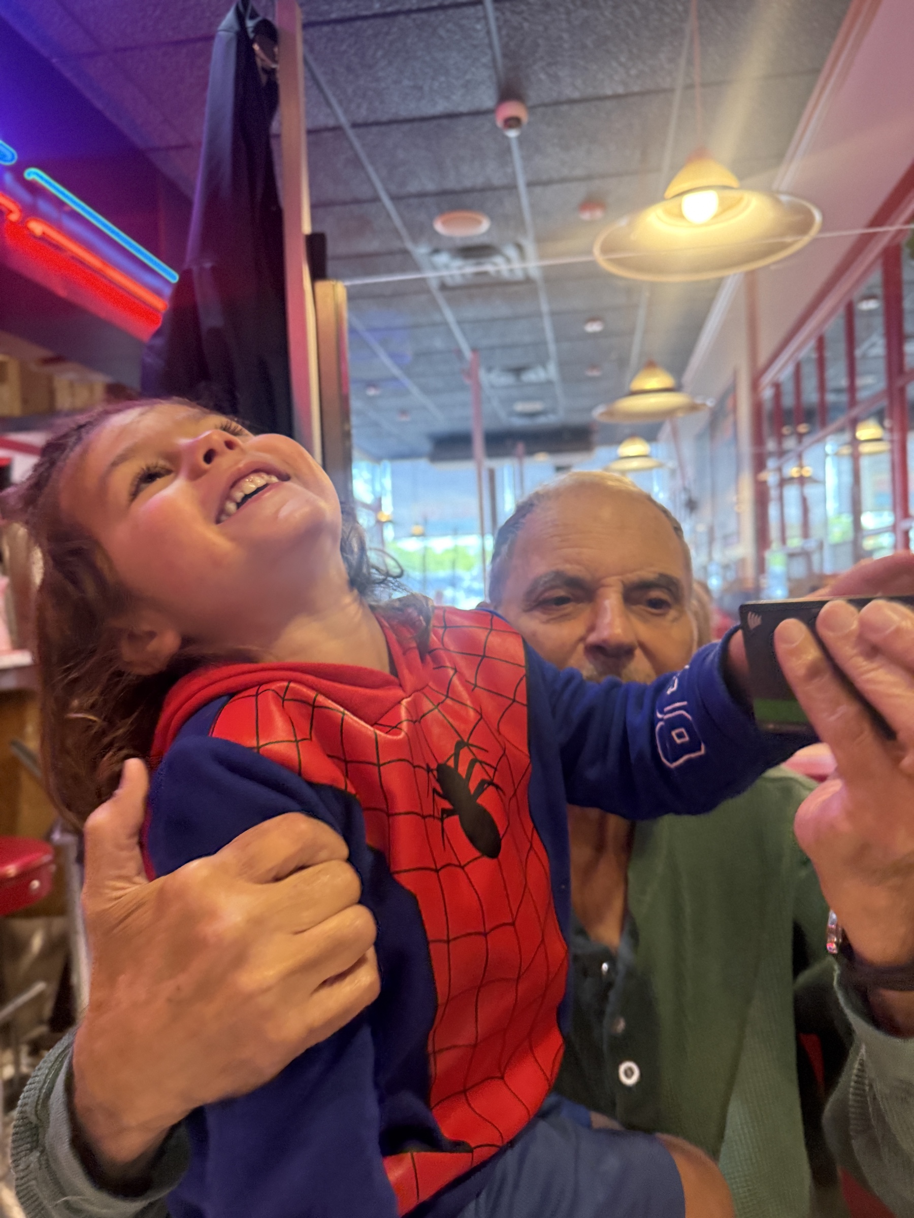 Morris holding his grandson Harry as they share a laugh