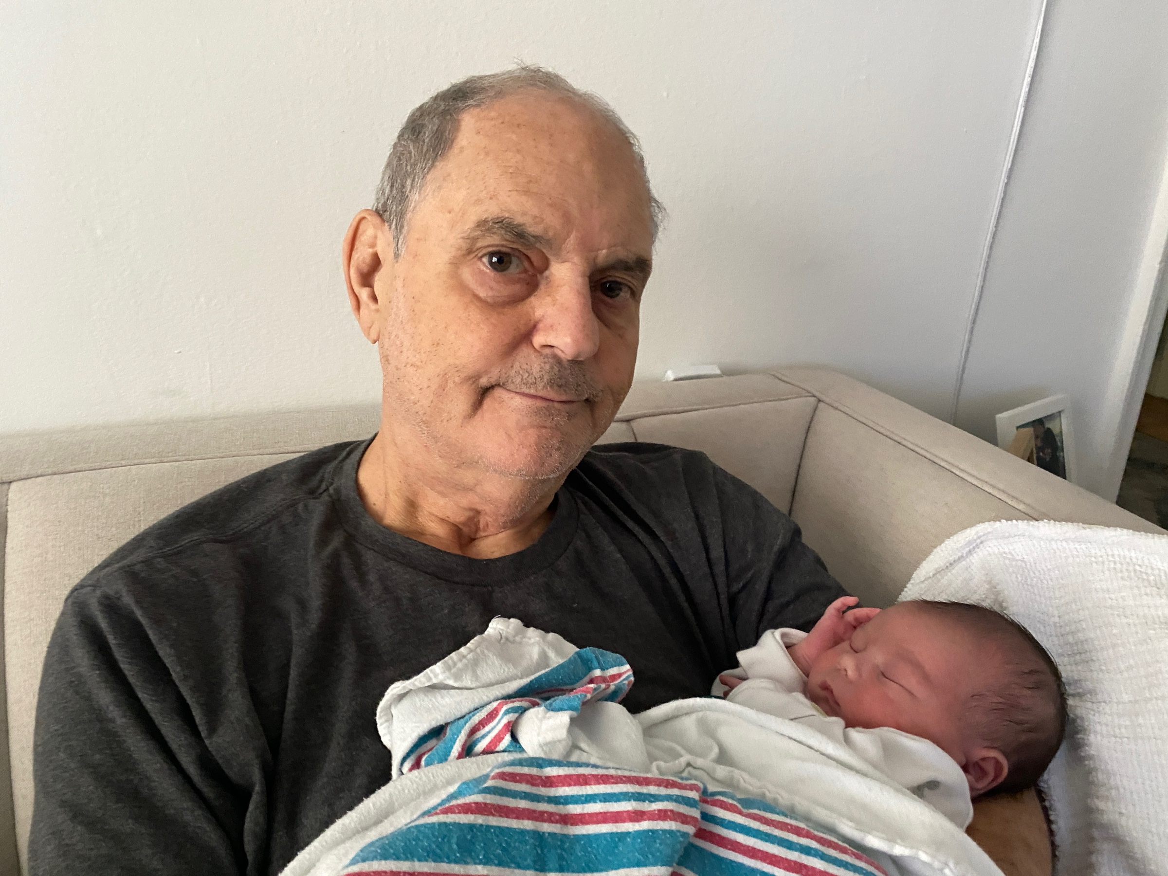 Morris holding a newborn member of the family